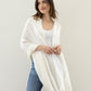 Pleated Plaid Milk Wrap in color Ivory on a model