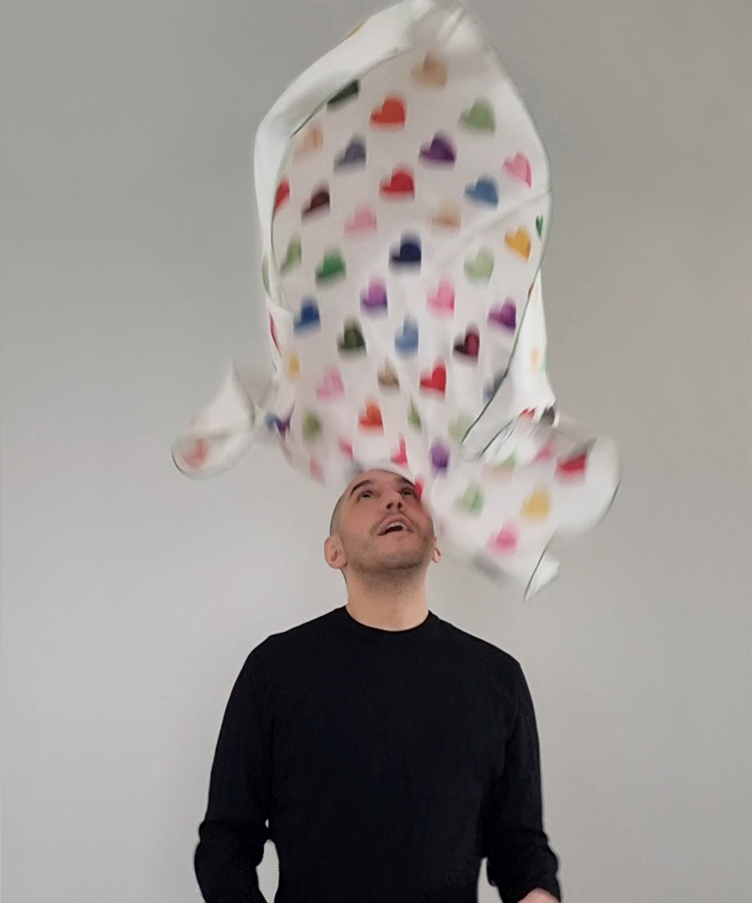 Man throwing Nuno Da Costa scarf in air