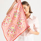 Model holding Sweetie Silk Bandana in color candy pink