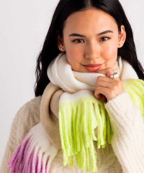Model wearing swizzle stick scarf in semolina colorway.