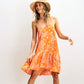 Woodcut Floral Tunic Dress in color Tangerine on a model