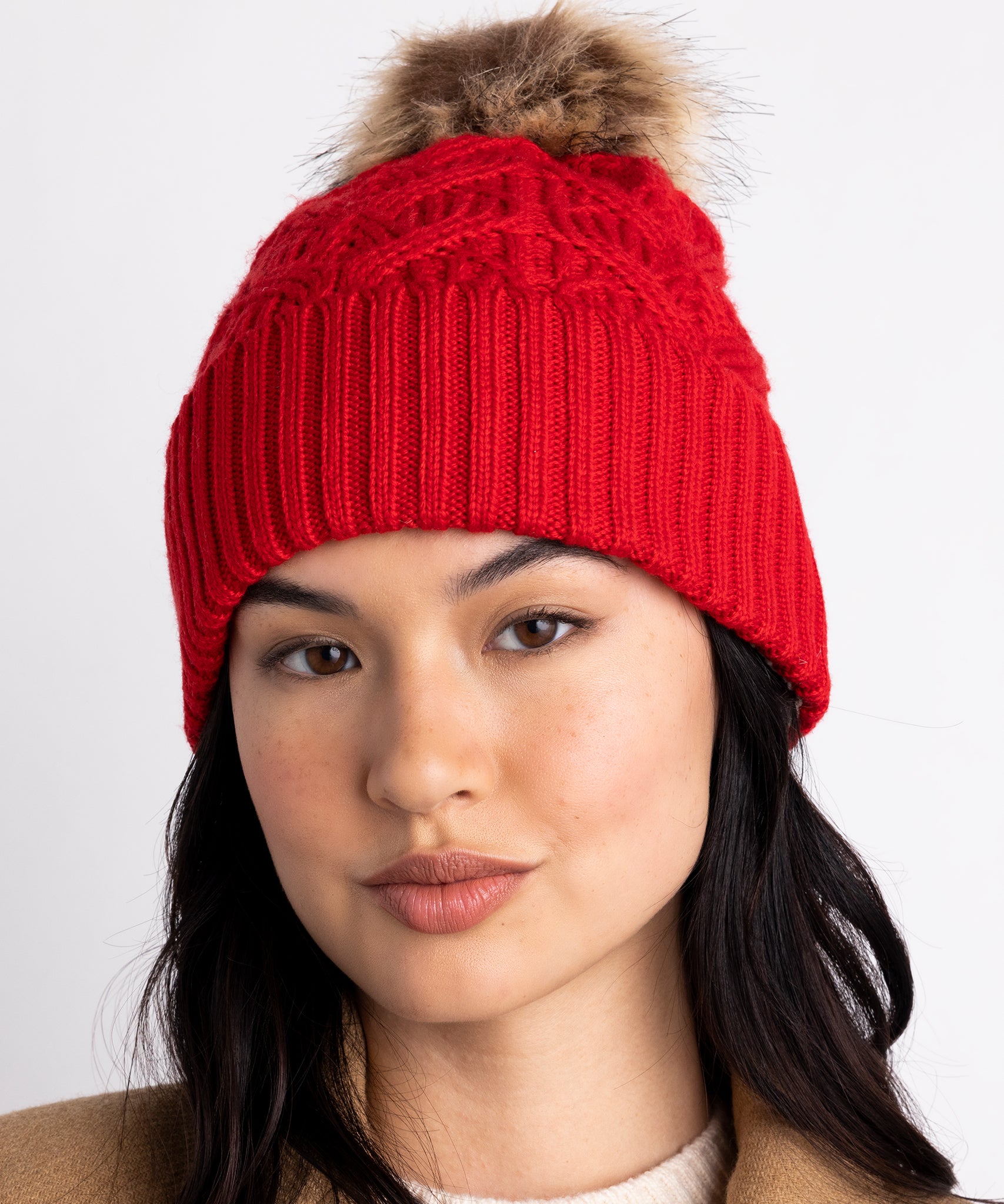 Loopy Cable Pom Hat in color Ruby Red on a model