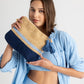 Tropic Stripe Clutch in color Natural/Navy held by model