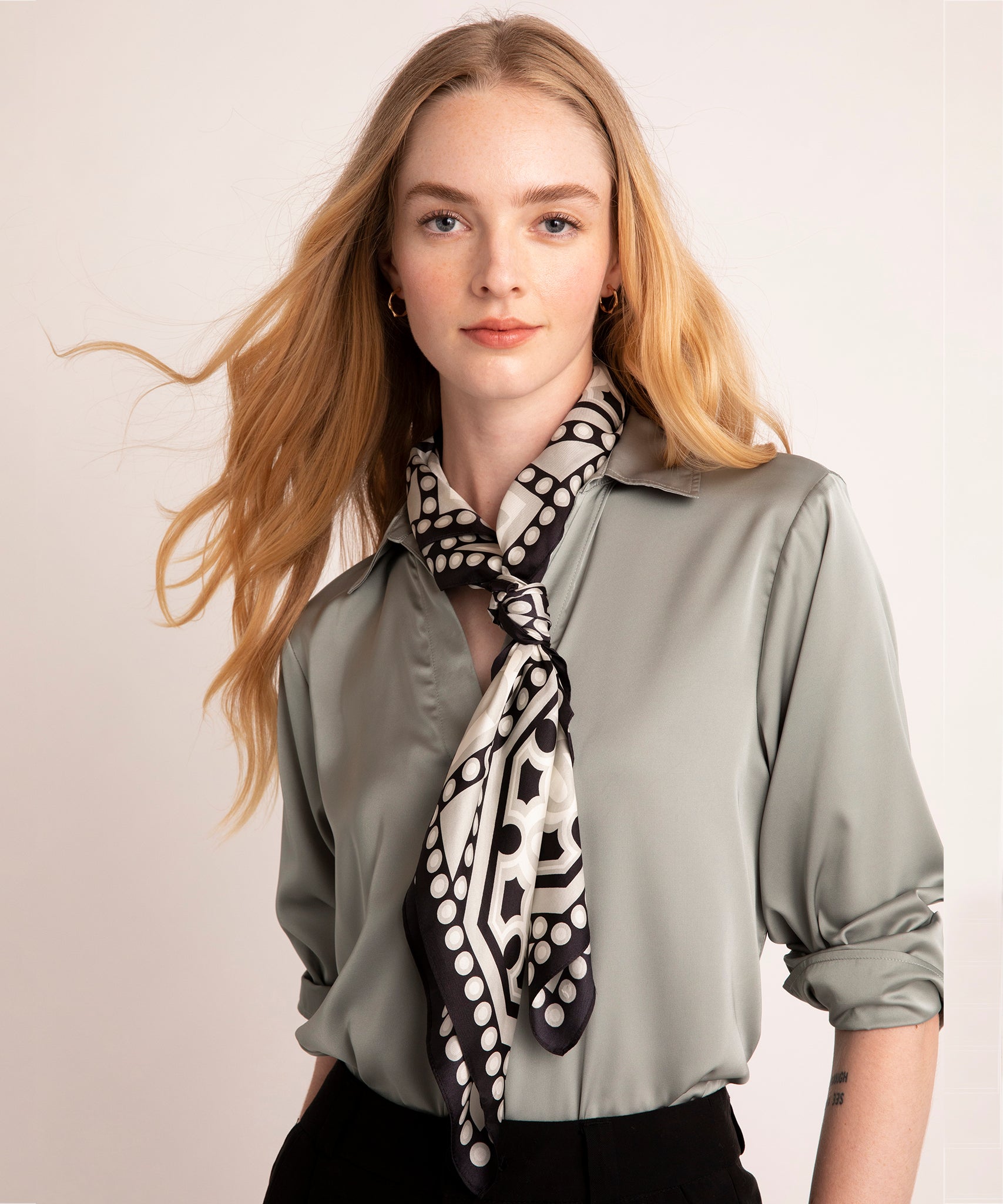 A model wearing The Marquee 35" Silk Square Scarf in Black