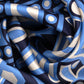 a close-up of The Marquee 35" Silk Square Scarf in Mystic Blue