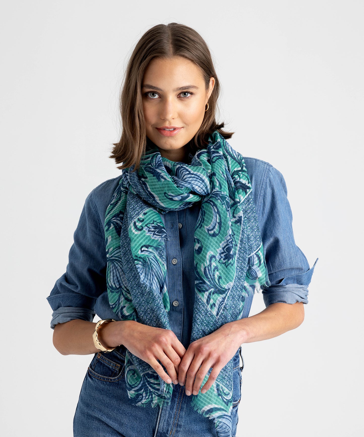 A model wearing the Tangled Vines Wrap in Island Green