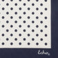 Navy blue square scarf with white polka dot pattern on a white background