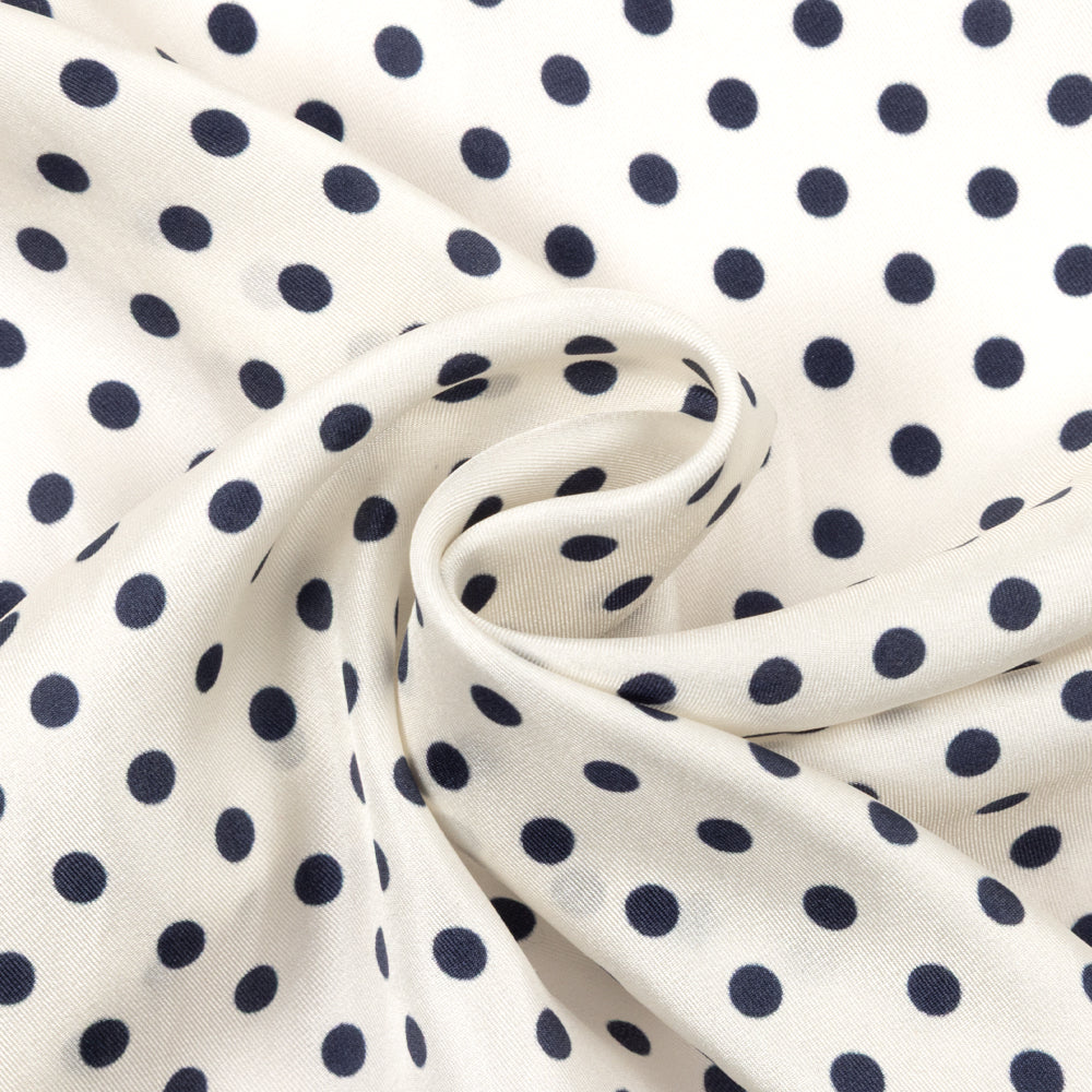 Navy blue square scarf with white polka dot pattern on a white background
