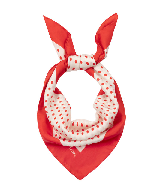 Red and white polka dot scarf on a white background