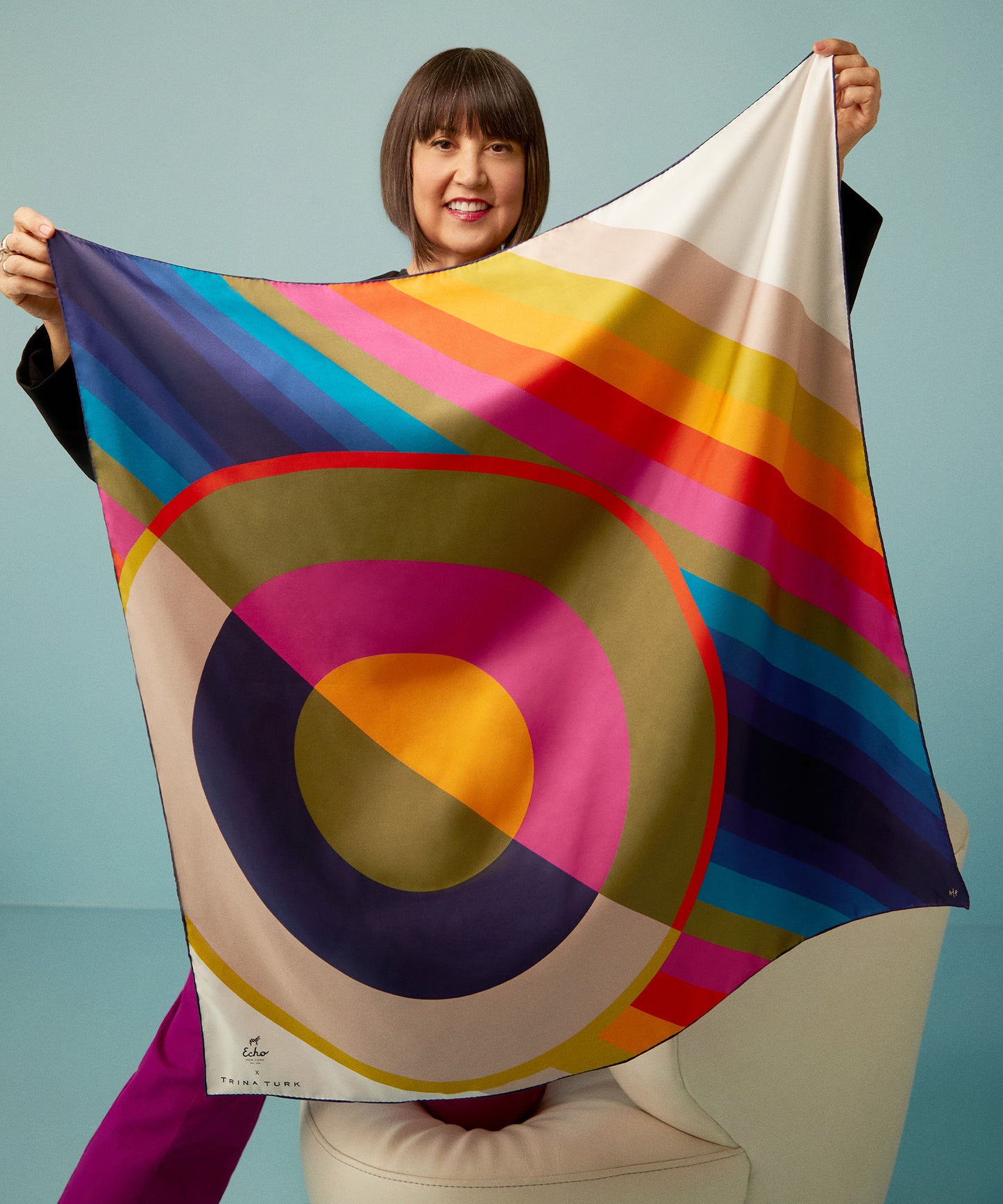 Trina Turk holding her limited-edition Echo100 scarf