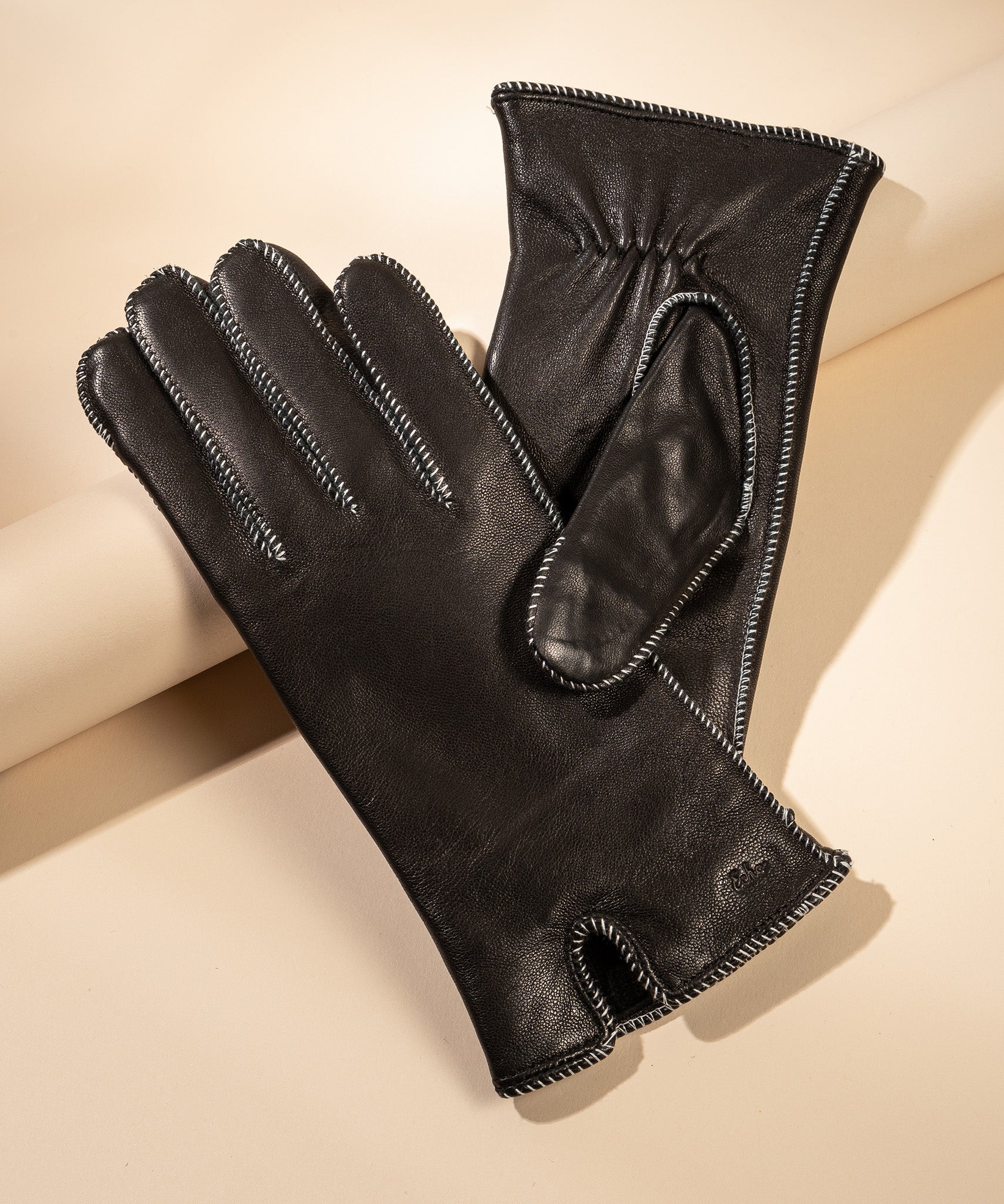 Whip Stitch Leather Glove in color Black/White still life